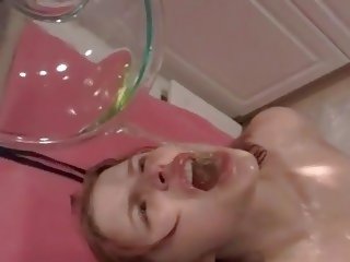 Young female drinks piss in fetish play